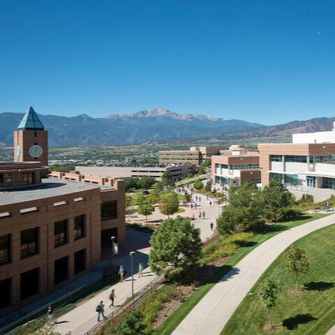 Photo of UCCS campus with clocktower and Pikes Peak in background.