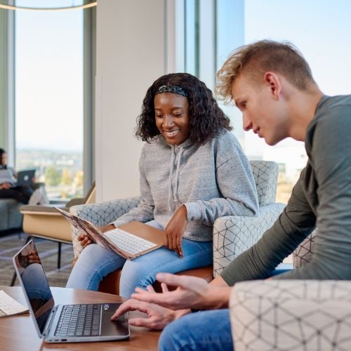 students sitting together on their computer