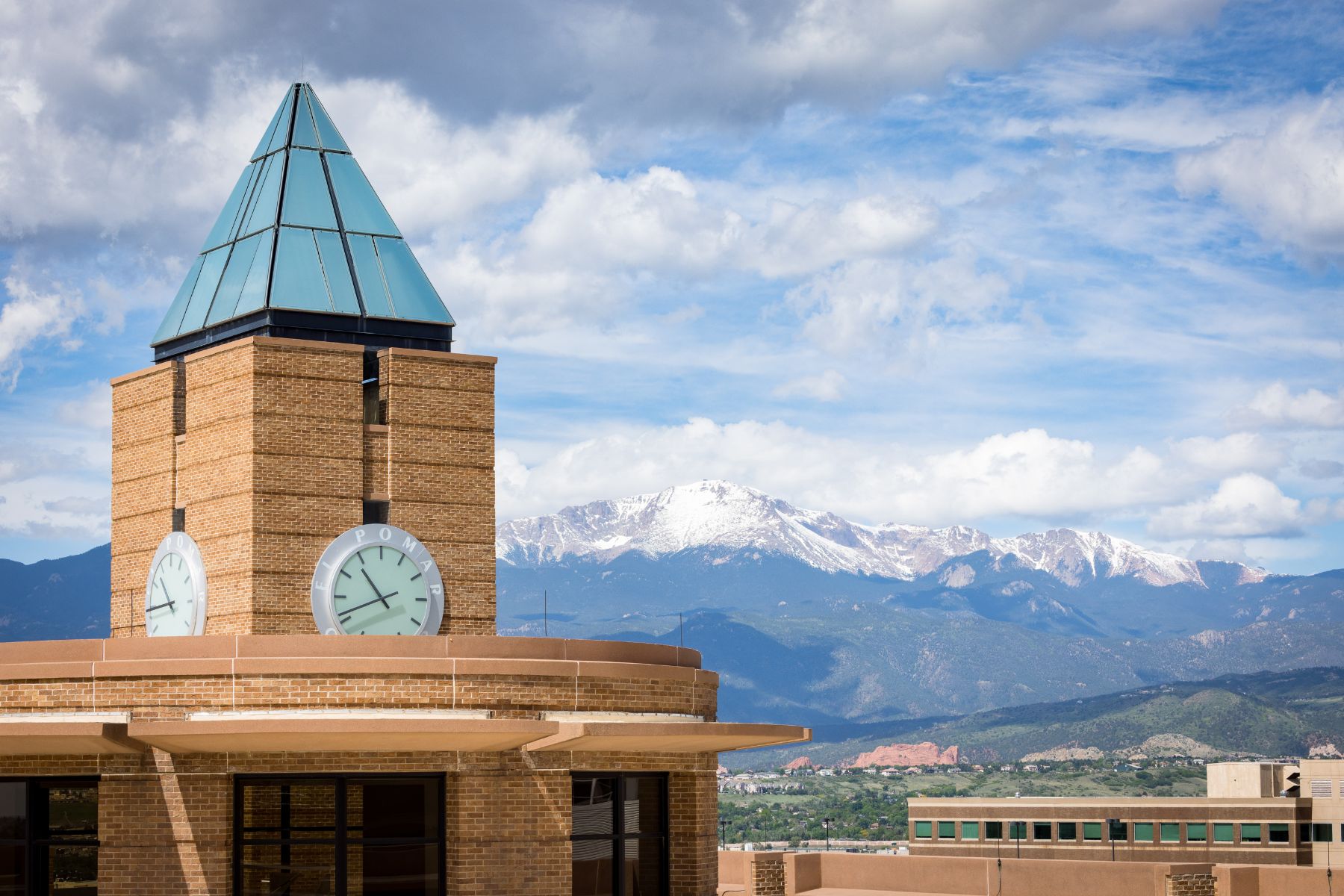 el pomar clock tower with pikes peak in the background