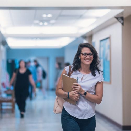 student walking in a hall on campus