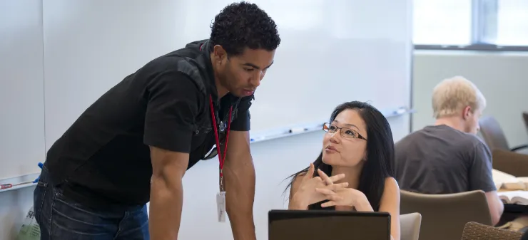 Students looking at a computer together