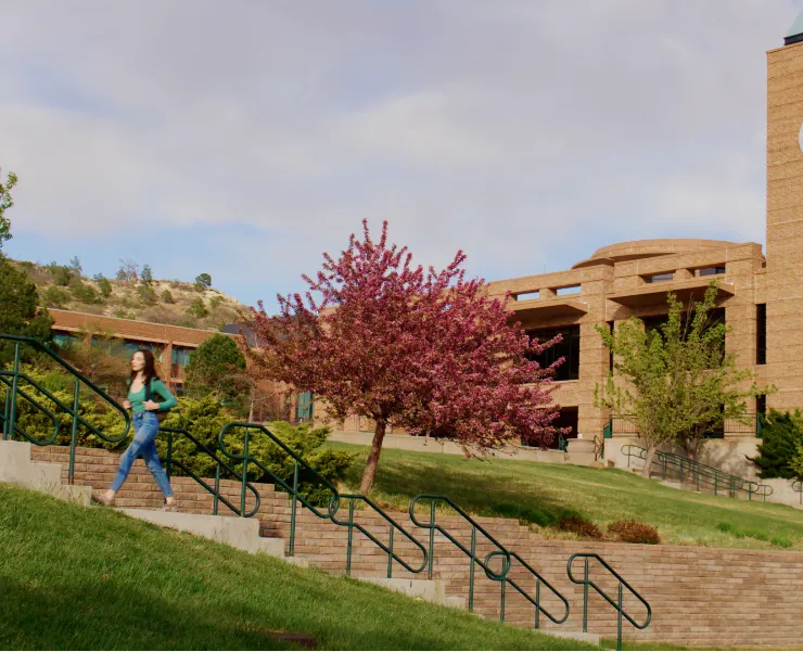Student walking by the El Pomar Clocktower