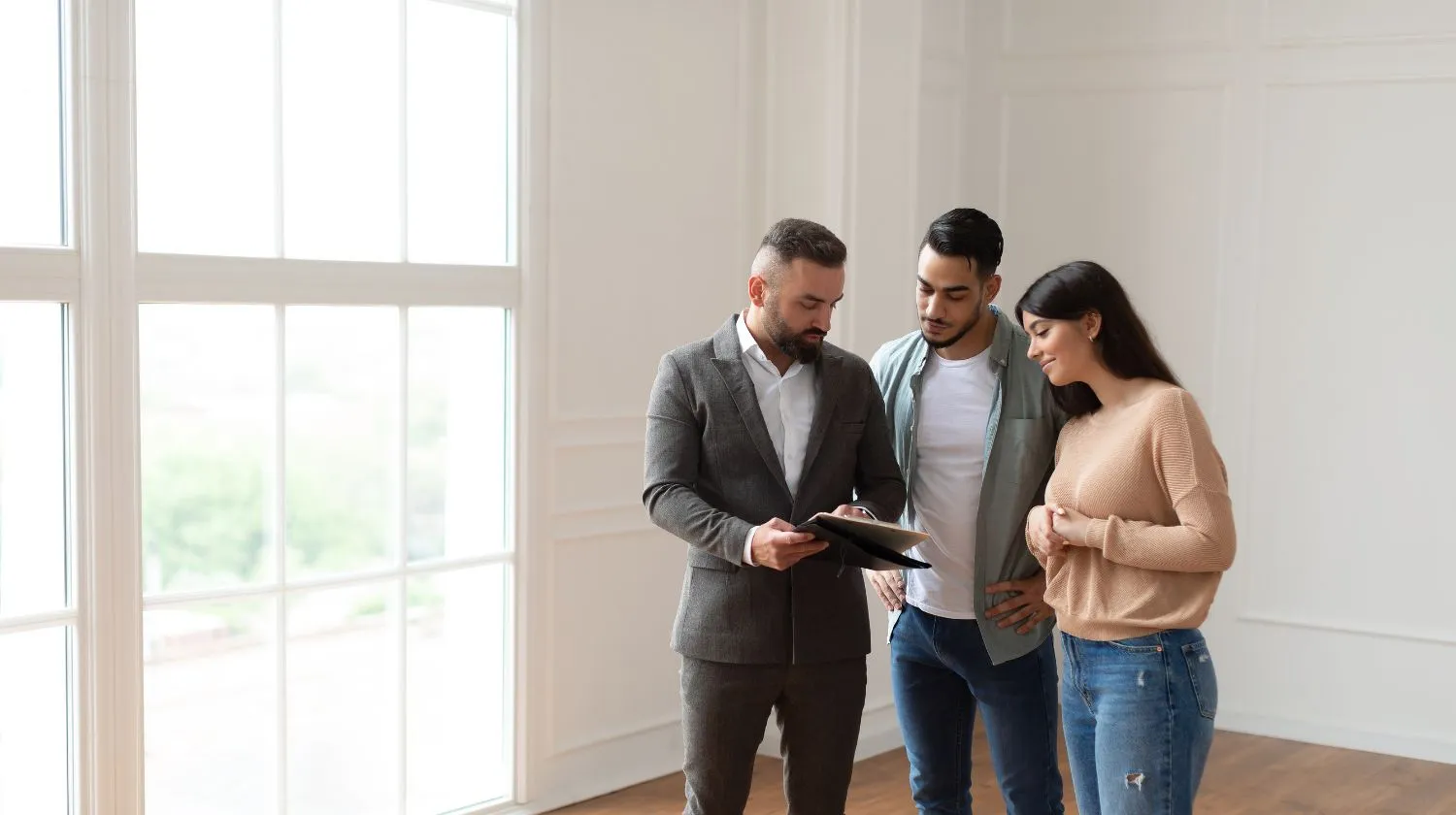 Real estate agent giving a property tour to a couple